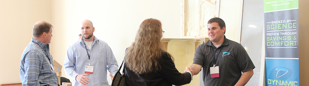 Conference sponsors speaking with attendees